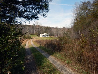 Driveway leading up to restored 1800s home on rural land